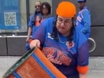 Angie Báez was caught on camera emptying a Knicks trashcan onto the street and then taking it. 