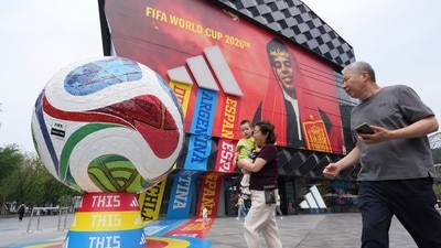 Visitors to a mall pass by retail promotion related to the FIFA World Cup in Beijing, China, Wednesday, June 24 (AP Photo/Ng Han Guan)