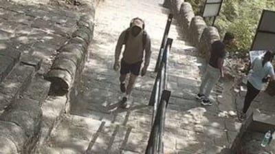 Chetan Chaudhary seen wearing a hoodie in the CCTV footage at the foothills of Lohagad on June 18. (Sourced) Chetan Chaudhary seen wearing a hoodie in the CCTV footage at the foothills of Lohagad on June 18. (Sourced)