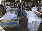 Patients lie outside a hospital evacuated after it was damaged in an earthquake in Catia La Mar, Venezuela.