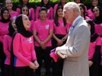 King Charles is presented with a hand decorated cricket bat from Shukria Noori during his meeting with members of the Afghan Refugee Women's Cricket Team at Clarence House on Wednesday.