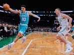 Charlotte Hornets guard Josh Green (10) grabs a loose ball against Boston Celtics guard Payton Pritchard (11) during the first half of a NBA basketball game, April 7, 2026, in Boston. 