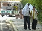 People cover themselves on a hot summer day at the National Zoological Park, in New Delhi, Thursday. (PTI)