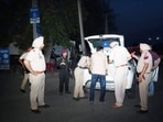 Police officials during a check near the village where the clash took place on Thursday.