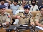 SSP Sanjai Kumar showing a pointed object allegedly used to torture the workers at the factory. (Sourced)
