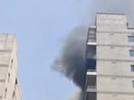 Smoke rises from the ninth floor of Golden-I building in Techzone 4 in Greater Noida. (HT Photo)