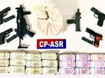 The seized firearms, cash and drugs in Amritsar. (ANI)