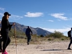 FILE PHOTO: Civilian volunteer searchers walk along Orange Grove Road while looking for clues in the disappearance of Nancy Guthrie, the 84-year-old mother of U.S. journalist and television host Savannah Guthrie, who went missing from her home, in Tucson, U.S., February 22, 2026. REUTERS/Rebecca Noble/File Photo