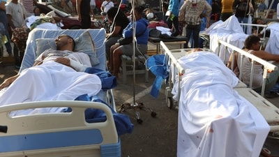 Patients lie outside a hospital evacuated after it was damaged in an earthquake in Catia La Mar, Venezuela. (AP) Patients lie outside a hospital evacuated after it was damaged in an earthquake in Catia La Mar, Venezuela. (AP)