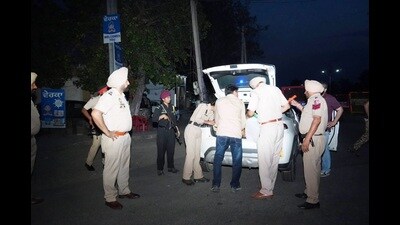 Police officials during a check near the village where the clash took place on Thursday.