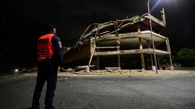 A Venezuelan municipal police officer stands next to a collapsed building following an earthquake in Valencia, Venezuela on June 24, 2026. Two earthquakes of magnitude 7.2 and 7.5 struck the same area of Venezuela on the evening of June 24, causing buildings to collapse, according to the United States Geological Survey (USGS) and AFP journalists. The quakes drove residents of the capital, Caracas, into the streets. (Photo by Jacinto OLIVEROS / AFP) (AFP) A Venezuelan municipal police officer stands next to a collapsed building following an earthquake in Valencia, Venezuela on June 24, 2026. Two earthquakes of magnitude 7.2 and 7.5 struck the same area of Venezuela on the evening of June 24, causing buildings to collapse, according to the United States Geological Survey (USGS) and AFP journalists. The quakes drove residents of the capital, Caracas, into the streets. (Photo by Jacinto OLIVEROS / AFP) (AFP)