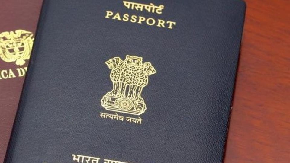 An Indian passport placed on top of a Colombian passport on a highly polished rosewood table. The passports are reflected on the polished wooden surface. The Indian passport has two booklets attached to each other denoting a much travelled holder. The holder obviously needed additional pages. The countries' details and emblems are in gold print on the documents' covers. Horizontal format. Copy space. (Getty Images/iStockphoto) (HT_PRINT)