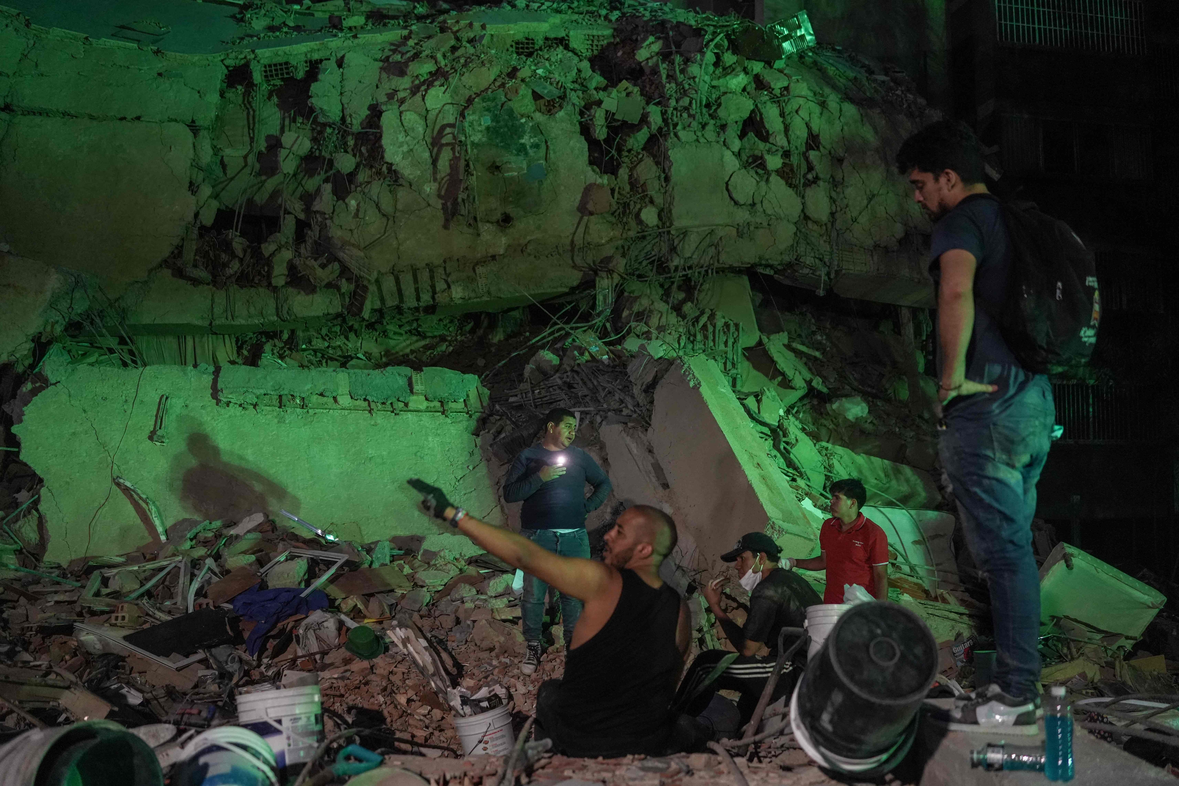 Rescuers work at the site of a collapsed building following an earthquake in Caracas on June 25, 2026. Powerful twin earthquakes have killed 32 people and injured more than 700, the nation's interim president said on June 25, after the massive shocks collapsed entire buildings and sent people running in panic. (Photo by Manaure QUINTERO / AFP) (AFP) Rescuers work at the site of a collapsed building following an earthquake in Caracas on June 25, 2026. Powerful twin earthquakes have killed 32 people and injured more than 700, the nation's interim president said on June 25, after the massive shocks collapsed entire buildings and sent people running in panic. (Photo by Manaure QUINTERO / AFP) (AFP)