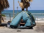 A man looks out from inside his tent, after Beirut municipality instructed displaced residents living on public sidewalks to move to official shelters, following the interim deal between the U.S. and Iran, in Beirut, Lebanon, June 25, 2026.