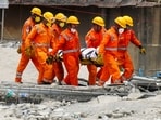 NDRF and Army officials carry the mortal remains of a victim during a rescue operation after an under-construction warehouse collapsed on Wednesday.