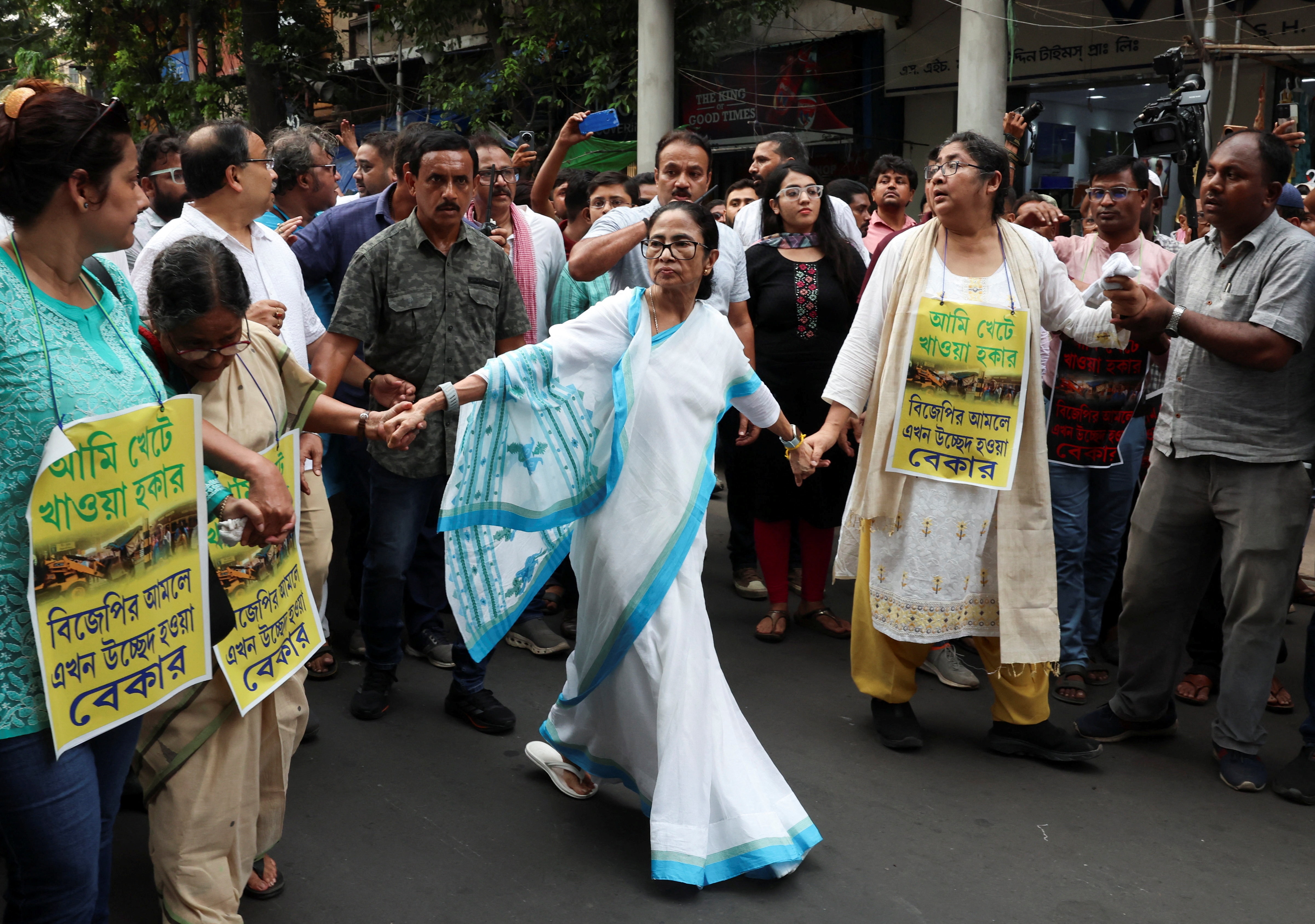 Former West Bengal chief minister Mamata Banerjee, along with party supporters, marches in protest following the evictions of hawkers in a recent anti-encroachment and demolition drive, in Kolkata, June 17. (REUTERS)