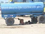 A man rests in shade under a water tanker in the city on Saturday. (Anil Kumar Maurya/HT)