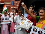 Members of the Indian National Trade Union Congress (INTUC) Seva Dal hold eggs during a protest over their various demands at the Kolkata Municipal Corporation Head office, in Kolkata on Thursday.