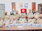 Amritsar commissioner of police Gurpreet Singh Bhullar (centre) on Saturday announcing the arrest of four individuals and the recovery of 10 sophisticated pistols along with nine cartridges. (HT Photo)