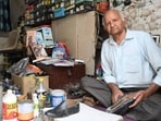 Author Dwarka Bharti in his shoe shop in Hoshiarpur. (Keshav Singh/HT)