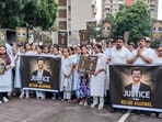Residents of Lodha Belmondo township participate in a silent march and candlelight vigil demanding justice for realtor Ketan Agarwal, in Pune. (PTI Photo)
