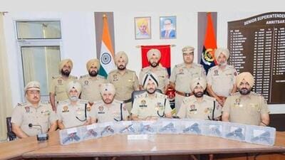 Amritsar commissioner of police Gurpreet Singh Bhullar (centre) on Saturday announcing the arrest of four individuals and the recovery of 10 sophisticated pistols along with nine cartridges. (HT Photo) Amritsar commissioner of police Gurpreet Singh Bhullar (centre) on Saturday announcing the arrest of four individuals and the recovery of 10 sophisticated pistols along with nine cartridges. (HT Photo)