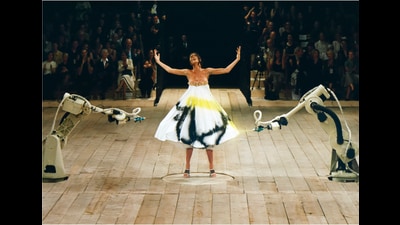 Model Shalom Harlow poses at the Alexander McQueen 1999 Spring/Summer show as robots spray paint onto her dress. (Getty Images) Model Shalom Harlow poses at the Alexander McQueen 1999 Spring/Summer show as robots spray paint onto her dress. (Getty Images)
