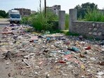 Garbage lying in front of the park in Shaheed Bhagat Singh Nagar, Ludhiana, on Sunday. (Gurpreet Singh/HT)