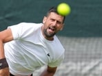 Novak Djokovic practices one day ahead of the start of the Wimbledon in London. (AP Photo/Kin Cheung)