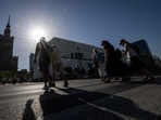 People walk through the street in the centre of Warsaw during the heatwave that has reached Poland on June 27, 2026.