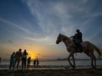 People at Dadar Beach during sunset, in Mumbai, Saturday, June 27, 2026. 