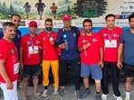 Participants showing their medals after the marathon in Baramulla on Sunday. (HT Photo)