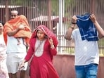 Visitors during a hot day at Red Fort in New Delhi on Saturday. 