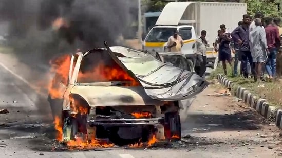 A car burns after catching fire on NH-48 near Sira in Tumakuru district, Karnataka. (PTI)