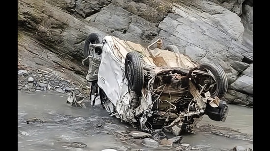 The mangled remains of the car that fell into gorge in Churah tehsil of Chamba district in Himachal Pradesh on Sunday. (HT Photo)