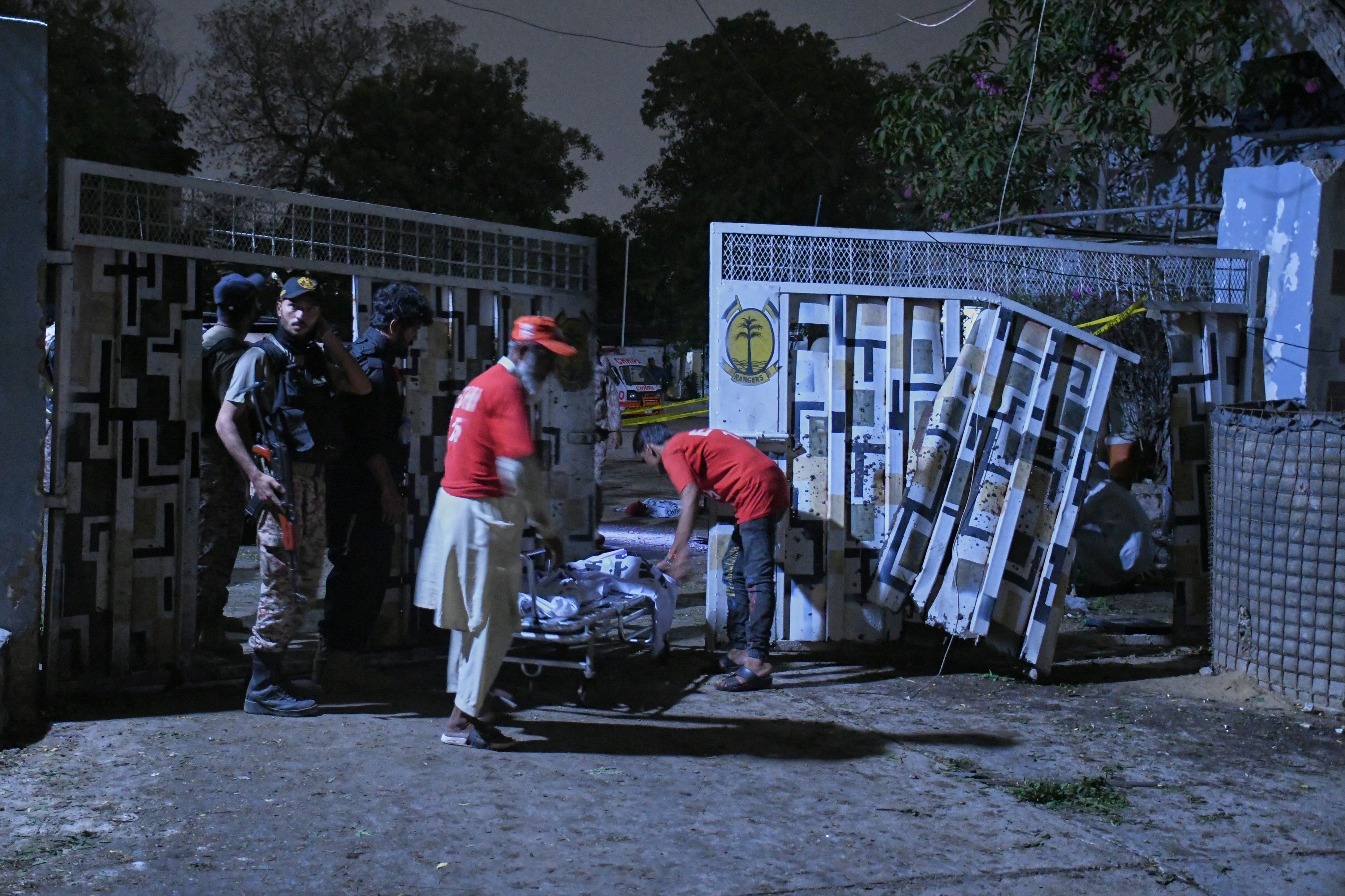Rescue workers carry a body away from the site of the militant attack in Karachi, Pakistan, on Sunday, June 28, 2026 (AP)