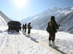 Indian army soldiers walk along a road near Zojila mountain pass that connects Srinagar to the union territory of Ladakh, bordering China on February 28, 2021. (Photo by TAUSEEF MUSTAFA / AFP) 