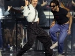 Viral videos sparked fears that extreme temperatures caused Harry Styles' fall at Wembley Stadium. However, reports say the singer briefly choked on water while performing his signature "whale" move (Photo by Adrian Dennis / AFP) 