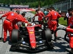 Mechanics work on the car of Ferrari's British driver Lewis Hamilton prior to the Formula One Austrian Grand Prix. (AFP)
