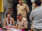 Police officials interrogate the family members of Ramashankar alias Tinnu Yadav, accused in connection with the embezzlement of donations at the Ram temple, in Ayodhya.