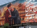 People move past a billboard with an image which depicts Iran's late Supreme Leader Ayatollah Ali Khamenei embracing late senior Iranian military commander General Qassem Soleimani, in Tehran, Iran, June 28, 2026. (via REUTERS)