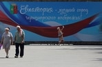 People walk along a street after local authorities in Crimea announced a state of emergency on the peninsula to deal with economic issues, amid the Russia-Ukraine conflict in the Black Sea resort city of Yevpatoriya, Crimea on June 26.