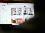 An internet user checks the Asian e-commerce giant Shein's website on a laptop in Paris. Two and a half years after it was introduced, Parliament definitively passed a bill on Monday aimed at curbing the some of the fast fashion, epitomised by Shein. However, the legislation focuses specifically on "ultra"-fast fashion in order to protect French jobs. 