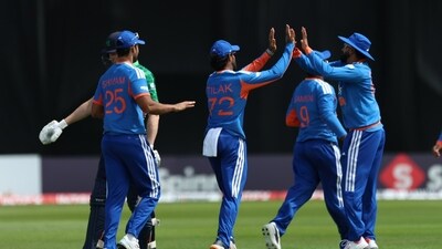 India's players celebrate the wicket of Ireland's Ross Adair. (Liam McBurney/PA via AP)