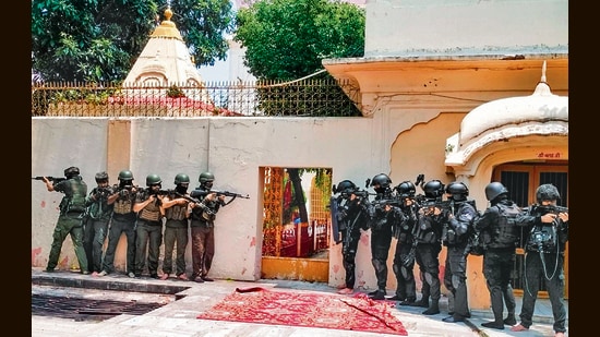 Jammu and Kashmir Police's Special Operations Group (SOG) and National Security Guard (NSG) personnel in action during a drill at Raghunath Temple ahead of the Amarnath Yatra, in Jammu on Monday. (ANI)