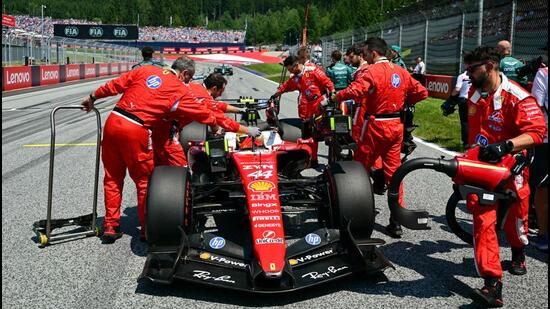 Mechanics work on the car of Ferrari's British driver Lewis Hamilton prior to the Formula One Austrian Grand Prix. (AFP)
