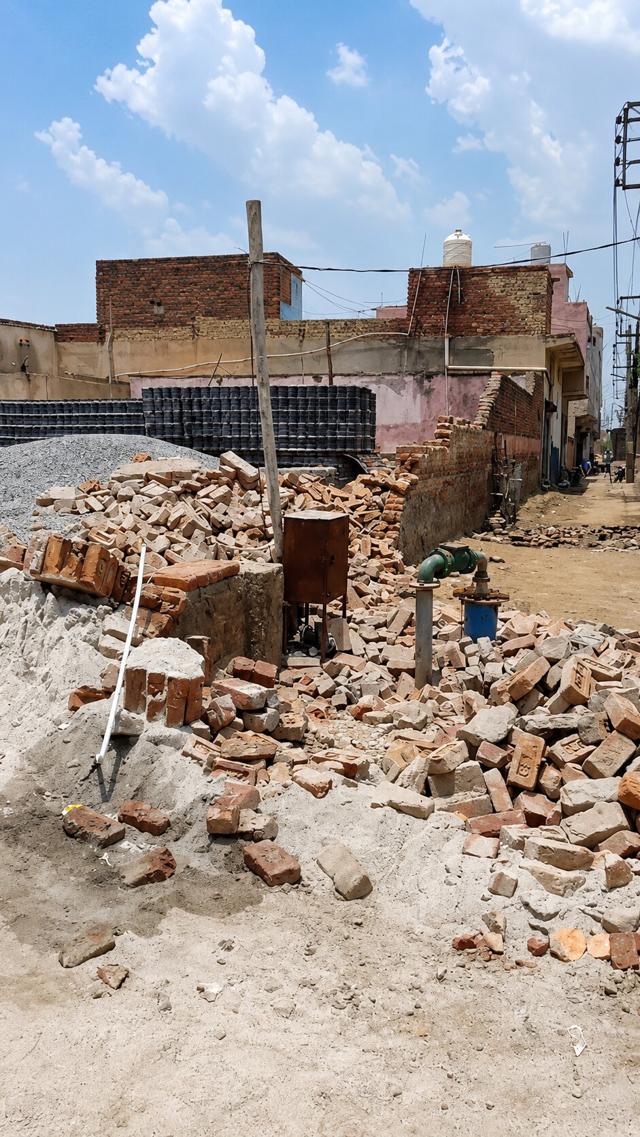 Residents later demolished the remaining wall and pelted stones at the contractors’ office, prompting police deployment to maintain order. (HT) Residents later demolished the remaining wall and pelted stones at the contractors’ office, prompting police deployment to maintain order. (HT)