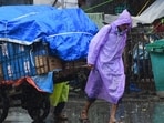 People going through the rain at Crawford Market in Mumbai, India, on Monday.