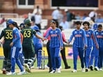 India's captain Harmanpreet Kaur (C) shakes hands with Australia's Ashleigh Gardner after Australia's victory in the Women's T20 world cup game 