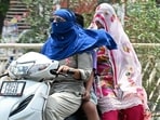 Commuters take cover from the scorching sun in Amritsar. Bathinda remained the hottest place in the state on Monday, with a maximum temperature of 44.4°C. (AFP)